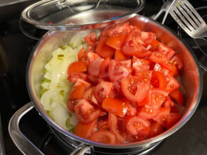 Onions, tomatoes, and jalapenos about to be stewed